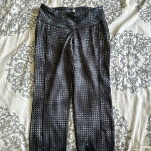 Grey patterned athletic pants. Cropped at about the knee/mid calf